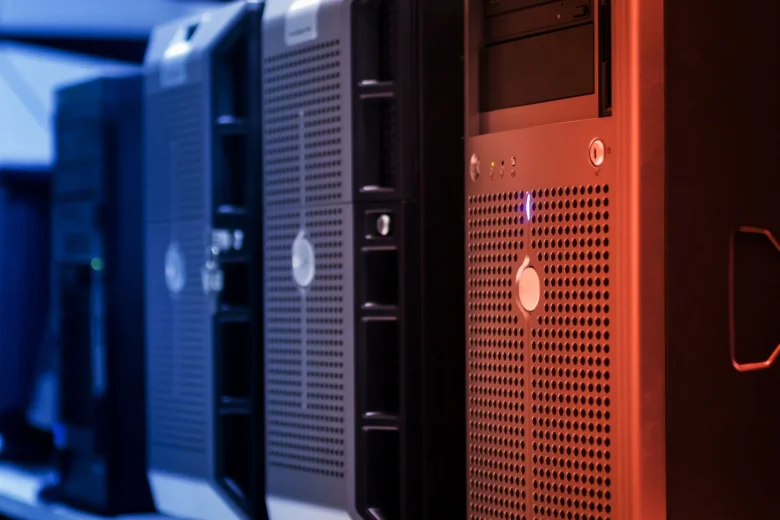 Rows of GPU servers in a data center with illuminated status LEDs.