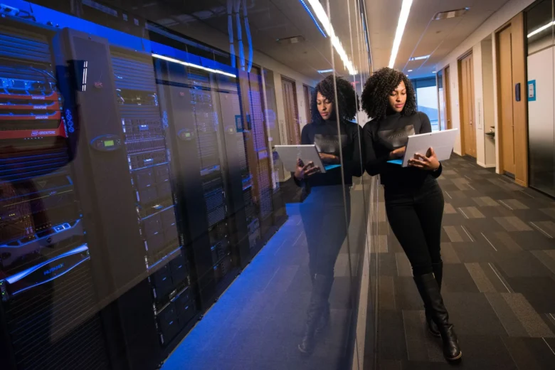 Rows of illuminated server racks inside a cloud data center running AI training jobs