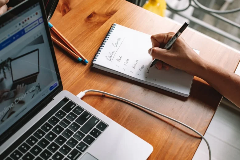 Professional following an online AI course on a laptop at a desk