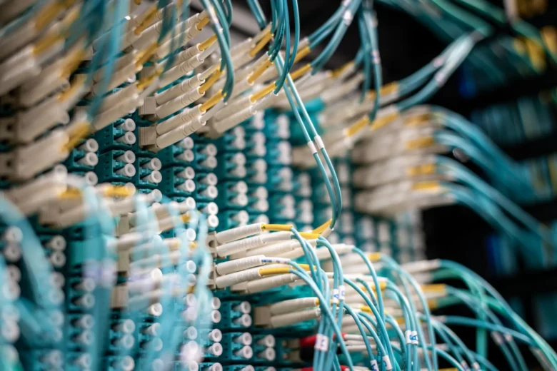 Rows of servers inside a modern European cloud data center connected by organized network cabling