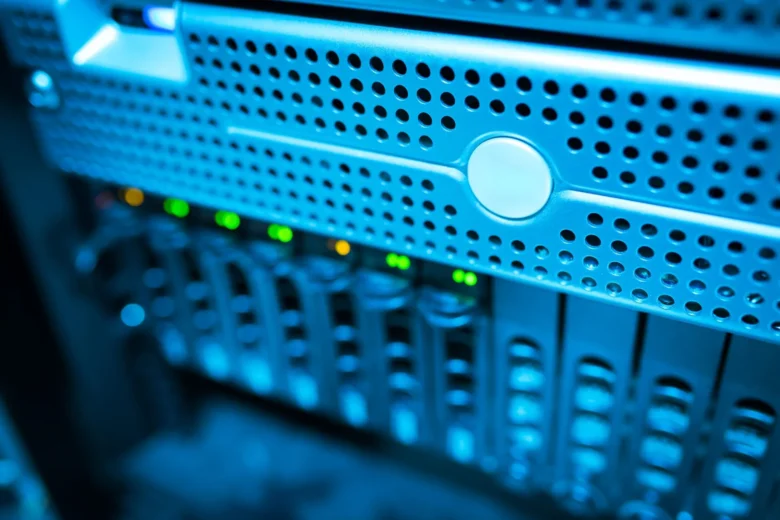 Rows of illuminated server racks inside a data center that hosts cloud AI training and inference workloads