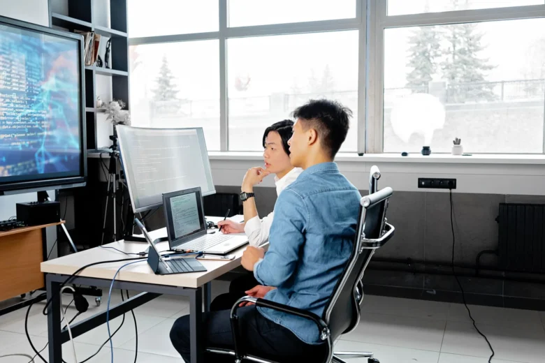 Developers reviewing API integration dashboards on shared screens