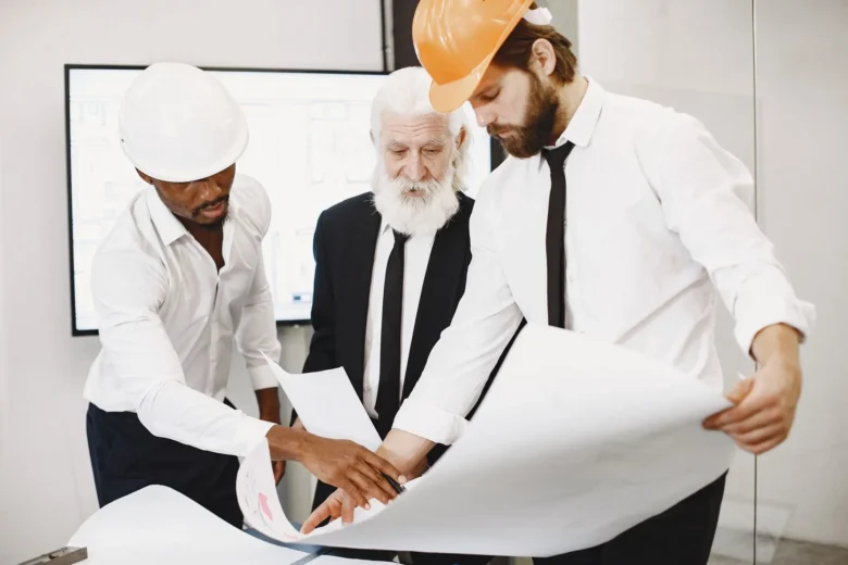Two engineers reviewing cloud AI architecture and compliance dashboards on large monitors