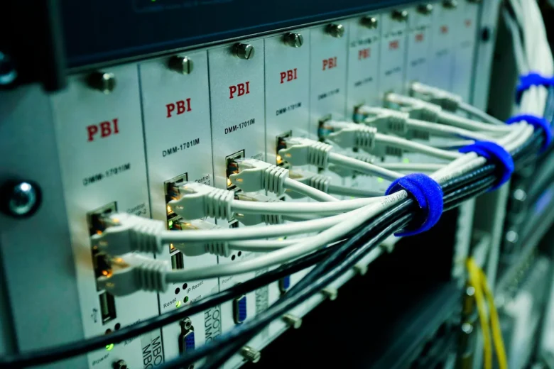 Rows of servers in a data center emitting blue light, illustrating cloud infrastructure that hosts AI workloads
