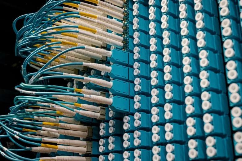 Rows of servers in a modern cloud data center with blue indicator lights, illustrating GPU infrastructure used for cloud AI workloads