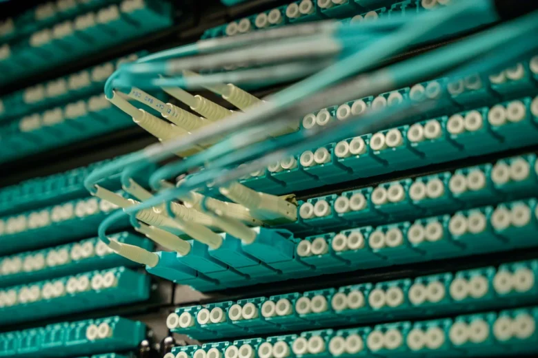 Rows of illuminated server racks inside a modern European data center, representing the cloud AI infrastructure that EU compliance rules govern.