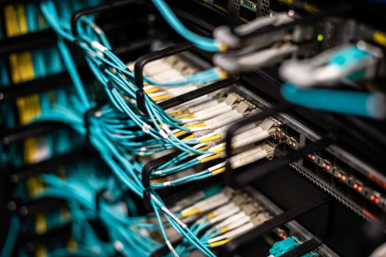 Rows of illuminated server racks inside a modern data center, representing cloud AI infrastructure capacity