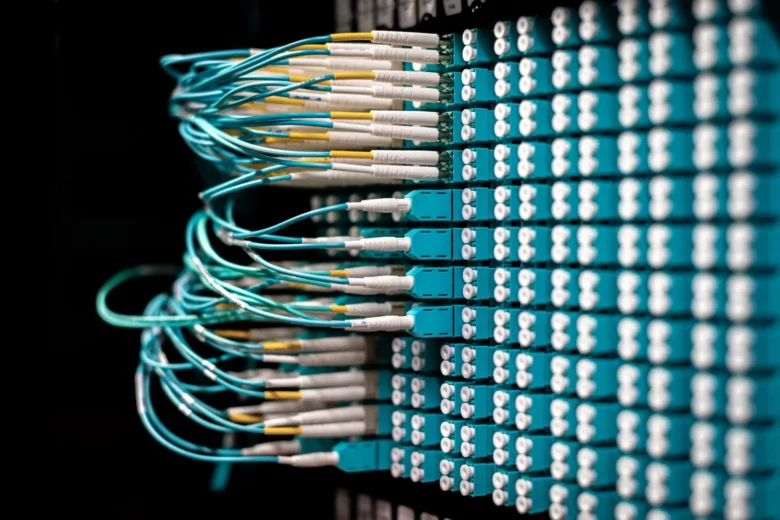 Rows of server racks in a blue-lit data center representing reserved AI inference capacity.