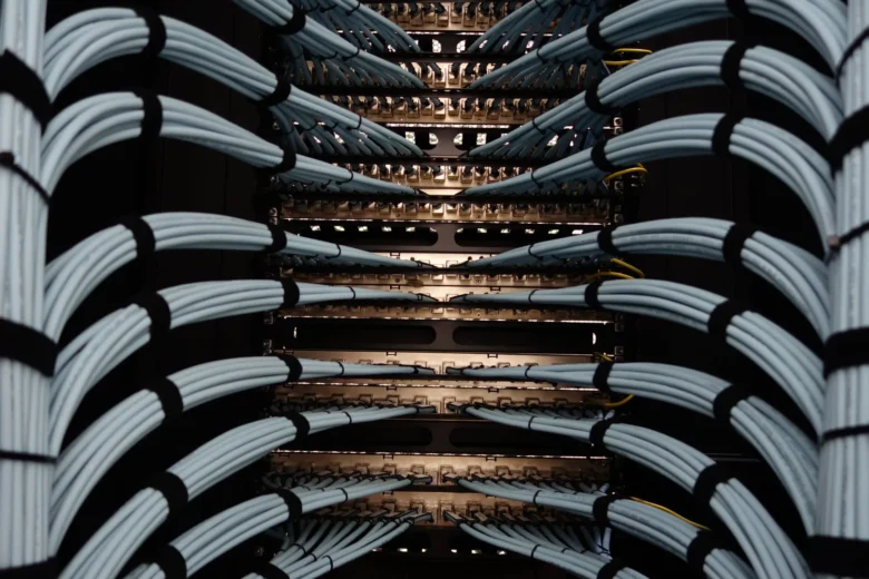 Rows of illuminated server racks inside a cloud data center, representing cloud AI infrastructure spend