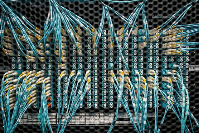 Rows of server racks in a data center, illustrating where cloud AI providers store prompt data before it is deleted