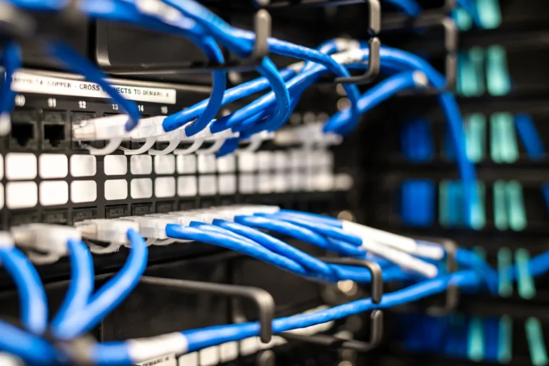 Racked servers with network cables in a data center being inspected during a security audit